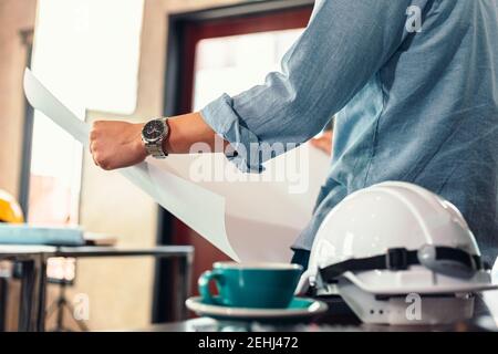 industry manager, engineer, businessman reading and checking blueprint, drawing  in the room. Engineer plan architecture concept. Stock Photo