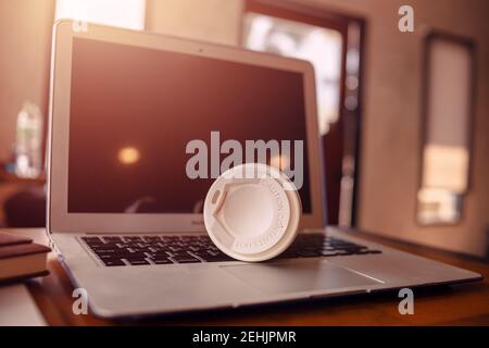 Empty cup of coffee on laptop in the office. Stock Photo
