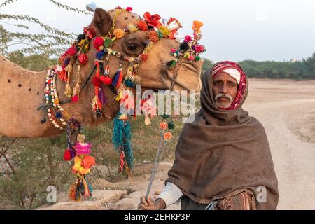 Old Man With Camel Near Abbassi Mosque near Derawar Fort, Yazman Tehsil, Punjab, Pakistan Stock Photo