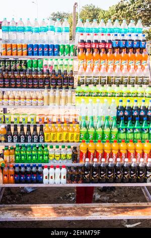 Various brand soda, fizzy drinks and fruit juices stacked up in open air shelf in Chennai marina beach Stock Photo