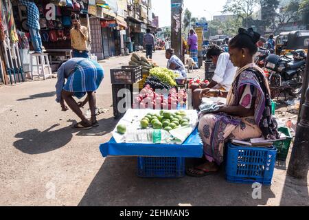 Street vendor selling fruits on roadside walking plafrom in George town in Chennai, Tamil Nadi, India Stock Photo