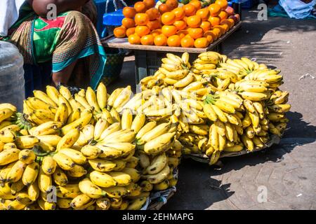 Street vendor selling fruits on roadside walking plafrom in George town in Chennai, Tamil Nadi, India Stock Photo