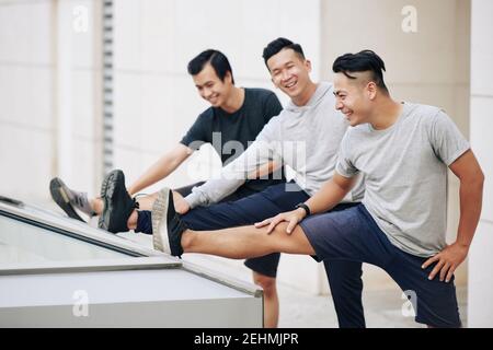 Sportsmen stretching legs Stock Photo