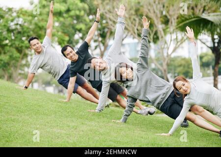 Young people doing side plank Stock Photo