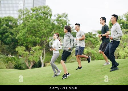 Sportsmen running in park Stock Photo