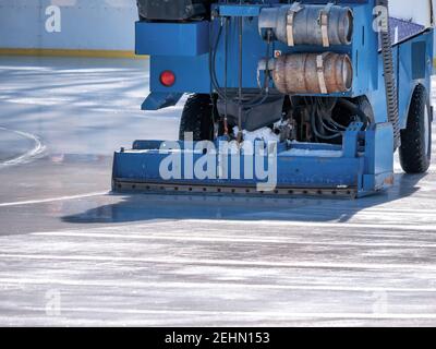 Ice resurfacer smoothing and polishing the surface of the ice rink Stock Photo