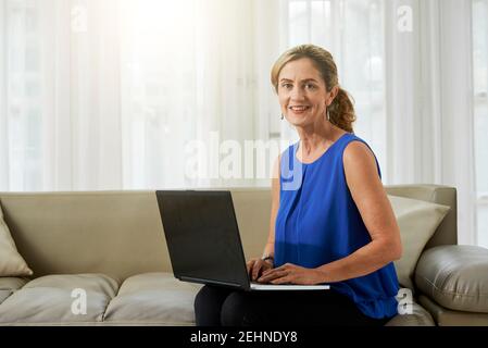 Mature woman working on laptop Stock Photo