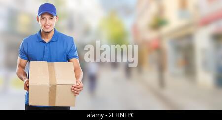 Parcel delivery service box package delivering town banner copyspace copy space job logistics young man outdoors Stock Photo