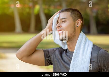 Break during running jogging sports training young man fitness workout outdoor Stock Photo