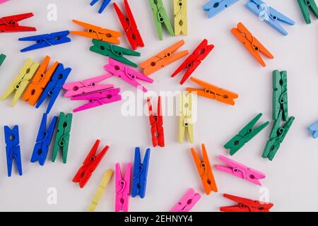 a multicolored clothespins on a white background Stock Photo