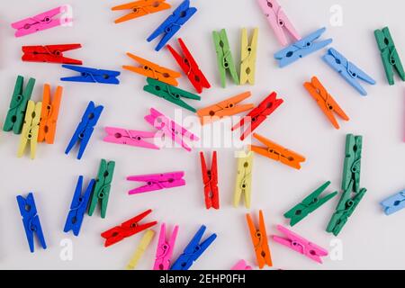 a multicolored clothespins on a white background Stock Photo