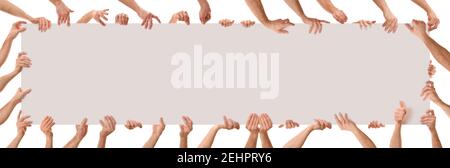 Many hands in different positions holding a poster with white isolated background. Panoramic composition Stock Photo