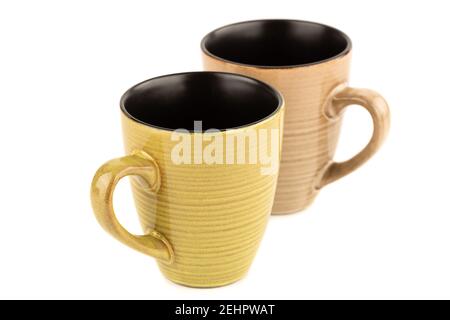 Two ceramic cups isolated on blue background. Stock Photo