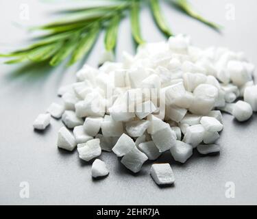 Dried sweet coconut cubes on a white background. Stock Photo