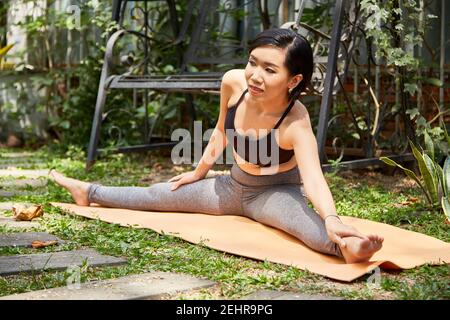 Fit woman doing splits Stock Photo