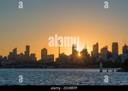 Looking west up Sydney Harbour, Australia, towards the silhouetted city ...