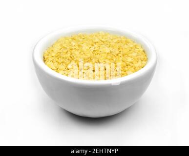 Millet flakes in a bowl isolated on white bacground. Stock Photo