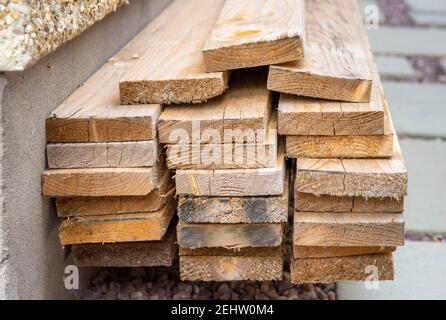 Pile of 4 x 1 bracing timber in garden Stock Photo