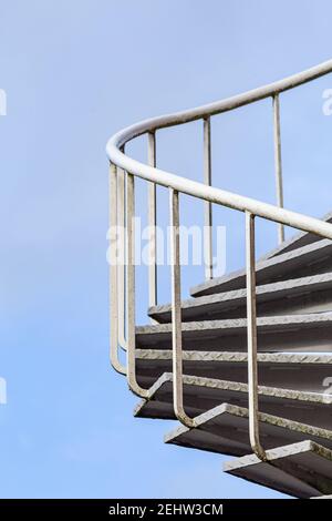 Spiral staircase with metal railing outside a building Stock Photo