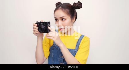 Asian woman using camera while smiling Stock Photo