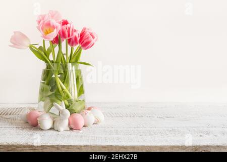 Spring Easter composition with pink tulips and eggs on light background. Space for text. Stock Photo