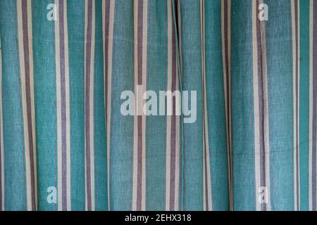 vintage green brown and white vertical striped fabric curtain Stock Photo