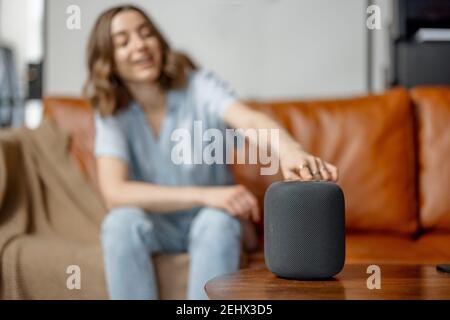 Woman speaking with audio assistant column  Stock Photo