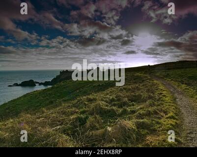 Path to Dunnottar Casle ruin in late afternoon light Stock Photo