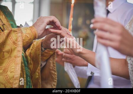 Bride and groom on the wedding engagement ceremony in orthodox church. Stock Photo