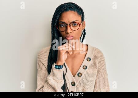 African american woman wearing casual clothes and glasses thinking concentrated about doubt with finger on chin and looking up wondering Stock Photo