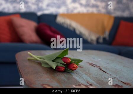 tulips on a old livingroom table Stock Photo