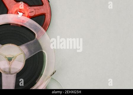 Roll of film on a green background. Magnetic tape reels. Old films on film. Retro style. Analog technology. Stock Photo