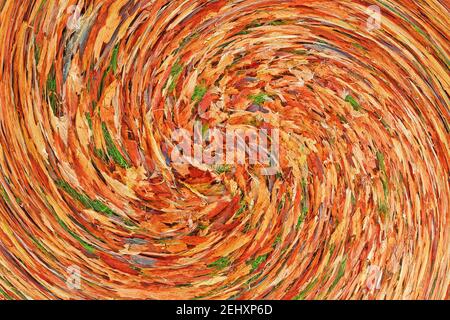 Abstract: Swirl or spiral of orange red Autumn leaves lying on green grass Stock Photo