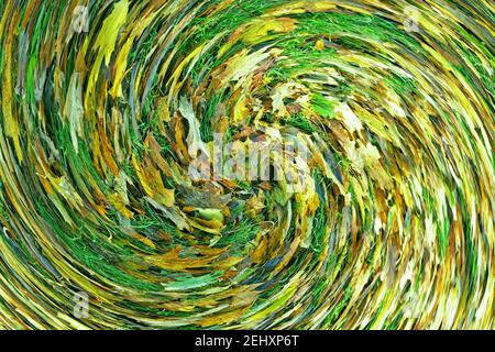 Abstract: Swirl or spiral of green tinted Autumn leaves lying on grass