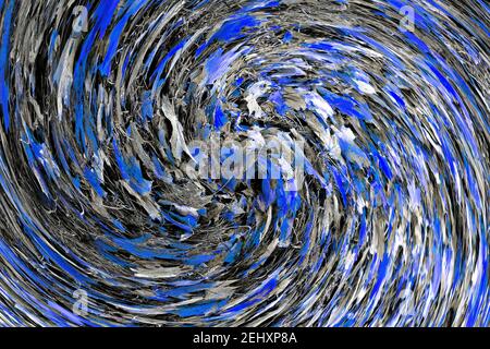 Abstract: Swirl or spiral of blue tinted Autumn leaves lying on grey grasses Stock Photo