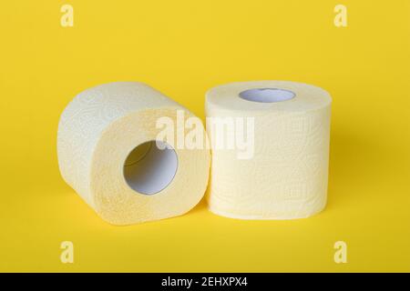 Two rolls of toilet paper on a yellow background. Personal hygiene concept Stock Photo