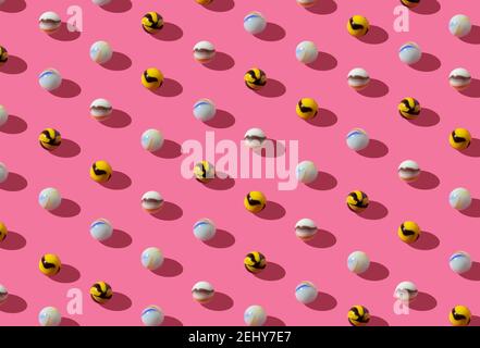 Pattern with vintage glass marbles in playful colors on a pink background. Retro isometric creative lyout. Stock Photo