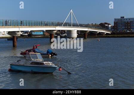 Two boats at anchor next to the Shoreham Adur Ferry Bridge which crosses the River Adur and link the main town to Shoreham by Sea. Stock Photo
