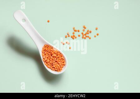 Red split lentils in white spoon Stock Photo