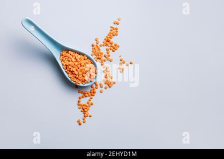 A spoonful of uncooked red split lentils Stock Photo