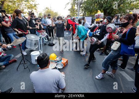 Pro-democracy protesters seen drumming during the demonstration. Pro-democracy protesters demonstrate demanding the prime minister to resign and reforms on the monarchy, outside the parliament building in Bangkok. Stock Photo