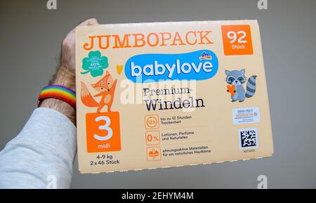 Strasbourg, France - Jan 16, 2021: POV personal perspective man holding new Jumbo Pack Babylove premium diapers pampers sold by Drogerie Markt DM store Stock Photo