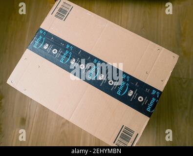 PAris, France- Jan 23, 2021: View from above of Amazon Prime cardboard box with double scotch tape on the front - the on-line retailer giant was founded by Jeff Bezos Stock Photo