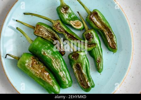 Green fresh chili peppers padron grilled or fried in the Spanish style Stock Photo