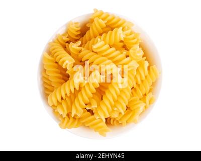 Pile of fusilli pasta in bowl isolated on white background.Тop view Stock Photo