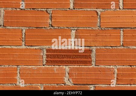 Red brick wall with textured surface creating a rustic and sturdy appearance for construction design Stock Photo