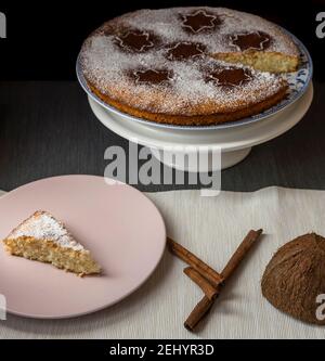 Coconut and lemon cake, covered with powdered sugar and cocoa powder Stock Photo