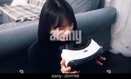 Asian woman holding VR glasses in her hands. High quality photo Stock Photo