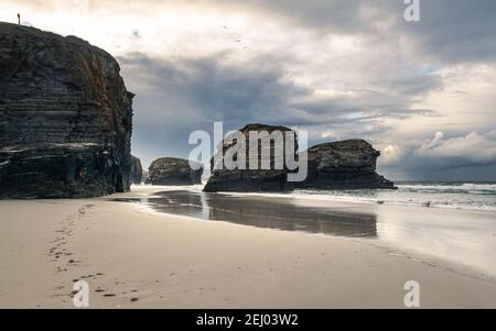 Scenic Playa de las Catedrales (Beach of the Cathedrals) featuring stunning rock arches, during low tide. Stock Photo