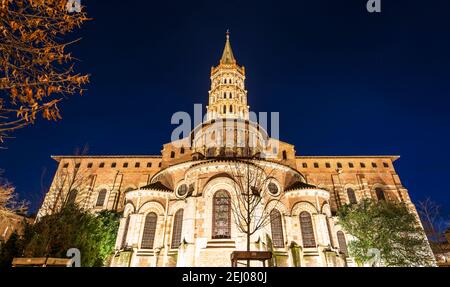 South-east side of the Saint Sernin Basilica with its monumental door, at night, in Toulouse in Occitanie, France Stock Photo